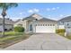 Charming single-story home featuring a two-car garage, a well-maintained lawn, and mature landscaping, providing excellent curb appeal at 314 Lady Diana Dr, Davenport, FL 33837