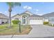 Charming single-story home featuring a two-car garage, a well-maintained lawn, and mature landscaping, providing excellent curb appeal at 314 Lady Diana Dr, Davenport, FL 33837