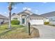 Charming single-story home featuring a two-car garage, a well-maintained lawn, and mature landscaping, providing excellent curb appeal at 314 Lady Diana Dr, Davenport, FL 33837