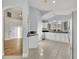 Bright kitchen features white cabinets, stainless steel appliances, and access to the living room at 314 Lady Diana Dr, Davenport, FL 33837