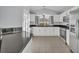 Bright kitchen features white cabinets, stainless steel appliances, and tile flooring at 314 Lady Diana Dr, Davenport, FL 33837