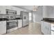 Modern kitchen features stainless steel appliances and white cabinetry with tile floors at 314 Lady Diana Dr, Davenport, FL 33837