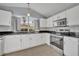 Well-lit kitchen features white cabinets, stainless steel appliances, and granite countertops at 314 Lady Diana Dr, Davenport, FL 33837