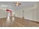 Open living room features wood floors, ceiling fan, and an open concept design to the kitchen at 314 Lady Diana Dr, Davenport, FL 33837