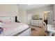 Spacious bedroom with a TV, a dresser, and easy access to an ensuite bathroom at 3333 Messina Dr, Lake Mary, FL 32746
