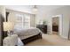 Bright bedroom with a large bed, a dresser with TV, and an ensuite bathroom at 3333 Messina Dr, Lake Mary, FL 32746
