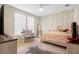 Bright bedroom with a ceiling fan, large window, and a cozy area rug at 3333 Messina Dr, Lake Mary, FL 32746