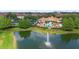 Aerial view of the community clubhouse, pool, tennis courts, and a pond at 3333 Messina Dr, Lake Mary, FL 32746