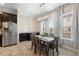 Stylish dining area with modern lighting and stainless steel refrigerator adjacent to dark cabinetry at 3333 Messina Dr, Lake Mary, FL 32746