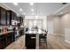 Well-appointed kitchen with island seating and sleek black cabinetry, perfect for entertaining at 3333 Messina Dr, Lake Mary, FL 32746