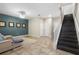 Spacious living room with a staircase, stylish decor, and tile flooring at 3333 Messina Dr, Lake Mary, FL 32746