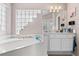 Bathroom offering a soaking tub with step and glass block details for added privacy at 346 Hickory Springs Ct, Debary, FL 32713