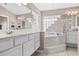 Bathroom showcasing a soaking tub with glass block accent and double sinks at 346 Hickory Springs Ct, Debary, FL 32713