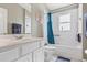 Bright bathroom featuring a tub with blue shower curtain, tiled walls, and white vanity with gold faucet at 346 Hickory Springs Ct, Debary, FL 32713