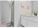 Clean, white bathroom featuring a glass-enclosed shower and vanity with ample counter space at 346 Hickory Springs Ct, Debary, FL 32713