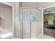 Bathroom featuring a walk-in shower with glass doors and tile surround at 346 Hickory Springs Ct, Debary, FL 32713
