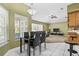 Bright eat-in kitchen with breakfast bar and open concept to living area with outdoor views at 346 Hickory Springs Ct, Debary, FL 32713