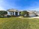 Attractive single-story house featuring a lush green lawn and beautiful landscaping at 346 Hickory Springs Ct, Debary, FL 32713