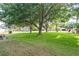 Spacious front yard with mature trees providing ample shade and a serene atmosphere at 346 Hickory Springs Ct, Debary, FL 32713