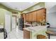 Eat-in kitchen features light countertops, wood cabinetry, and a breakfast bar at 346 Hickory Springs Ct, Debary, FL 32713