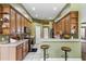 Bright kitchen boasts granite countertops, breakfast bar, wood cabinets, and gas range at 346 Hickory Springs Ct, Debary, FL 32713