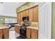 A bright, airy kitchen featuring wooden cabinets, stainless steel appliances, and a view into the living area at 346 Hickory Springs Ct, Debary, FL 32713