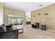 Comfortable living room with sliding doors to screened porch, neutral carpeting, and ample natural light at 346 Hickory Springs Ct, Debary, FL 32713