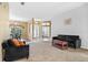 Inviting living room featuring neutral walls, a cozy sofa, and an open layout to the dining area at 346 Hickory Springs Ct, Debary, FL 32713