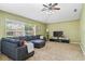 A bright living room with a large window and a comfortable gray sectional sofa at 346 Hickory Springs Ct, Debary, FL 32713