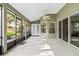 Enclosed patio offering versatile space with a ceiling fan and screens for fresh air at 346 Hickory Springs Ct, Debary, FL 32713