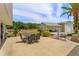 Spacious backyard featuring a dining area, a lush green lawn, and a charming outdoor structure at 36408 E Eldorado Lake Dr, Eustis, FL 32736