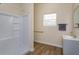 Bright bathroom features a shower, modern vanity, and wood-look floors at 36408 E Eldorado Lake Dr, Eustis, FL 32736