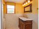 Bathroom featuring a classic vanity with a marble countertop and decorative mirror at 36408 E Eldorado Lake Dr, Eustis, FL 32736
