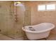 Relaxing bathroom with a freestanding tub and a glass-enclosed shower, enhanced by natural light at 36408 E Eldorado Lake Dr, Eustis, FL 32736