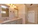 Well-lit bathroom with double sinks, vanity, and tiled walls, offering style and functionality at 36408 E Eldorado Lake Dr, Eustis, FL 32736