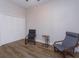 Bedroom features two chairs, wood-look flooring, and a large closet at 36408 E Eldorado Lake Dr, Eustis, FL 32736