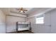 Bedroom featuring a bunk bed, a ceiling fan, and natural light from a window at 36408 E Eldorado Lake Dr, Eustis, FL 32736