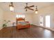 Spacious bedroom features hardwood floors, French doors, and a stylish ceiling fan at 36408 E Eldorado Lake Dr, Eustis, FL 32736
