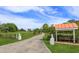 Long driveway leading to a ranch style house on a large lot with split rail fence and mature landscaping at 36408 E Eldorado Lake Dr, Eustis, FL 32736