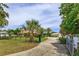 Gated driveway leading to a well-maintained home and garage at 36408 E Eldorado Lake Dr, Eustis, FL 32736