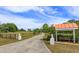 Long driveway leading to the home with charming entry features at 36408 E Eldorado Lake Dr, Eustis, FL 32736