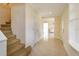 Inviting entryway with tiled floors and stairs leading to the upper level of the home at 36408 E Eldorado Lake Dr, Eustis, FL 32736