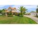 Well-manicured front yard with lush landscaping and a detached garage at 36408 E Eldorado Lake Dr, Eustis, FL 32736
