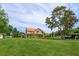 Home surrounded by lush lawn and mature trees in the front yard at 36408 E Eldorado Lake Dr, Eustis, FL 32736