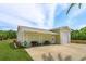 Detached garage with multiple bays, featuring a light green exterior and spacious driveway, offering ample parking at 36408 E Eldorado Lake Dr, Eustis, FL 32736