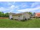 A large three car garage sits in a landscaped yard, enhancing the property's functionality and curb appeal at 36408 E Eldorado Lake Dr, Eustis, FL 32736
