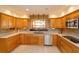 Well-equipped kitchen with modern appliances, tiled backsplash, and ample counter space at 36408 E Eldorado Lake Dr, Eustis, FL 32736