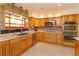Modern kitchen with stainless steel appliances, a window over the sink, and ample cabinetry at 36408 E Eldorado Lake Dr, Eustis, FL 32736