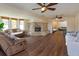 Spacious living room with wood floors, stone fireplace, and multiple seating areas at 36408 E Eldorado Lake Dr, Eustis, FL 32736