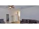 Living room featuring wood floors, a leather sofa, and a glass cabinet at 36408 E Eldorado Lake Dr, Eustis, FL 32736
